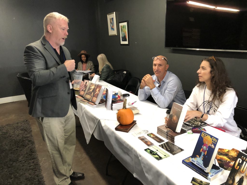 Kevin Grogin, author of 'Black Sheep White Cop: Savannah EXPOsed,' talks with Jack Simmons, author of 'Three Dashes Bitters,' and publisher Leigh E. Rich at the 2019 Savannah Authors Expo.