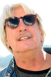 Author and journalist Christopher Leppek, with The Stanley Hotel reflected in his sunglasses. ©Shari Valenta